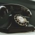 Black Rotary Telephone on White Surface